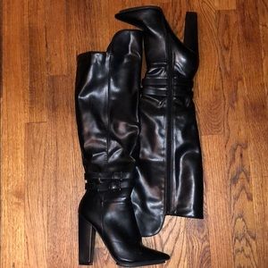 Black knee high leather boots with side buckles